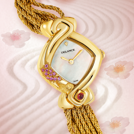 Yuka : Montre en or gravée et sertie de 10 saphirs roses, cadran nacre blanche ou rose, aiguilles dorées, cabochon avec un rubis à 6h, bracelet en brins d'or